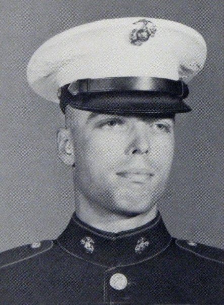 Bob McNeil in United States Marine Corps dress blues and a white peaked cap, photographed in black and white