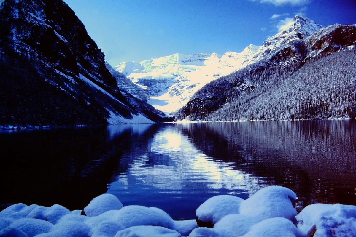 Snow-covered peaks mirrored in Lake Louise, Canada, photographed on 35mm film in 1978