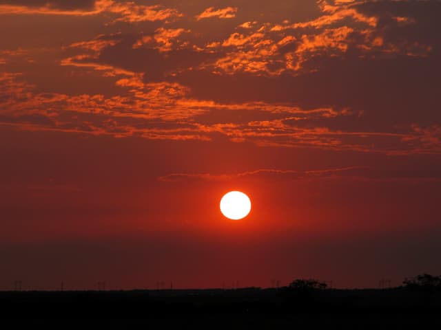 Sun 02, a sunrise and sunset photograph by Bob McNeil