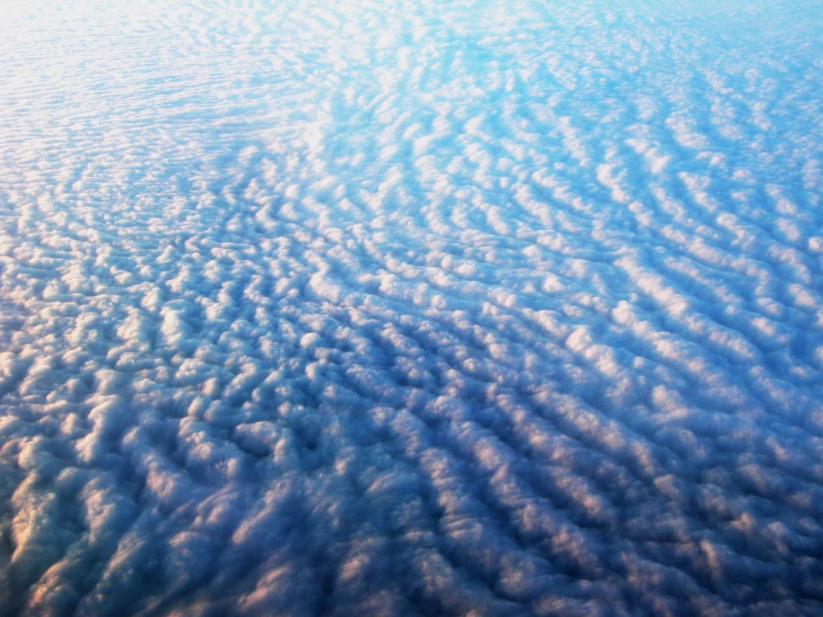 Looking Down at the Tops of Clouds, a aerial photograph by Bob McNeil
