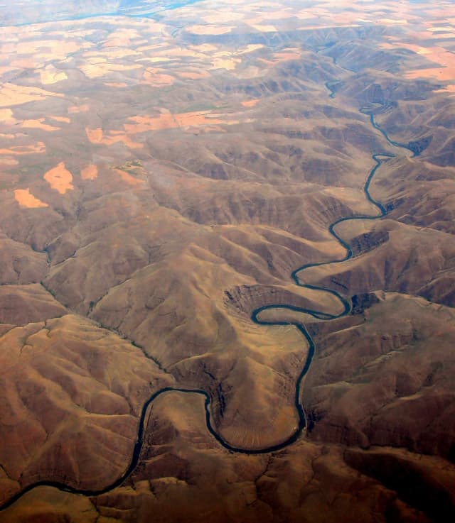River Cuts Through Mountains, a aerial photograph by Bob McNeil